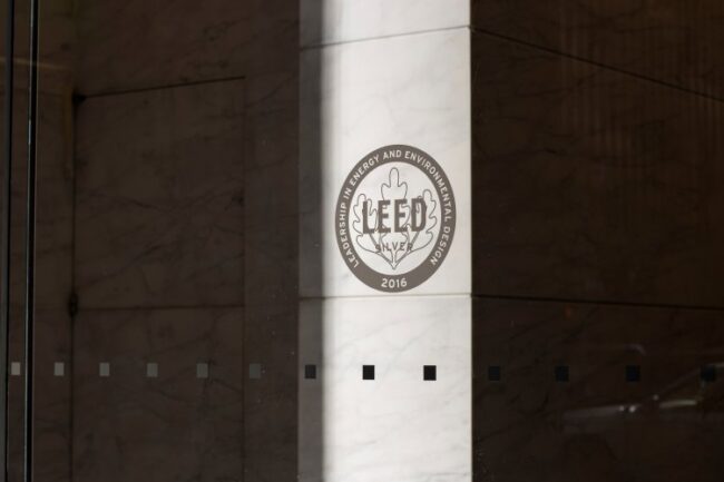 New York, NY, USA – July 2, 2022: LEED Silver certificate icon is seen at the entrance to an office building. LEED (Leadership in Energy and Environmental Design) is a green building rating system. leed